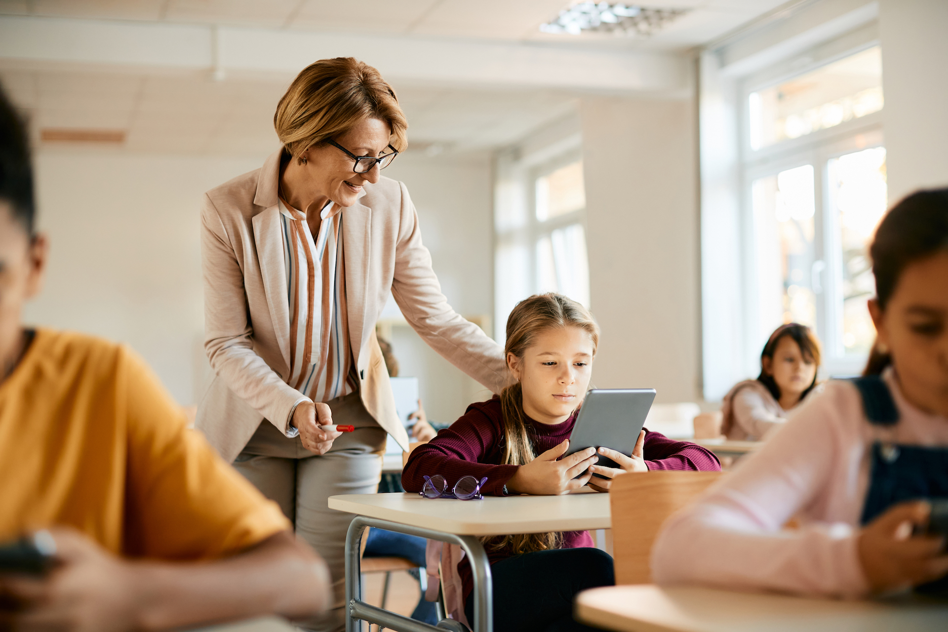 Teacher supporting student in classroom