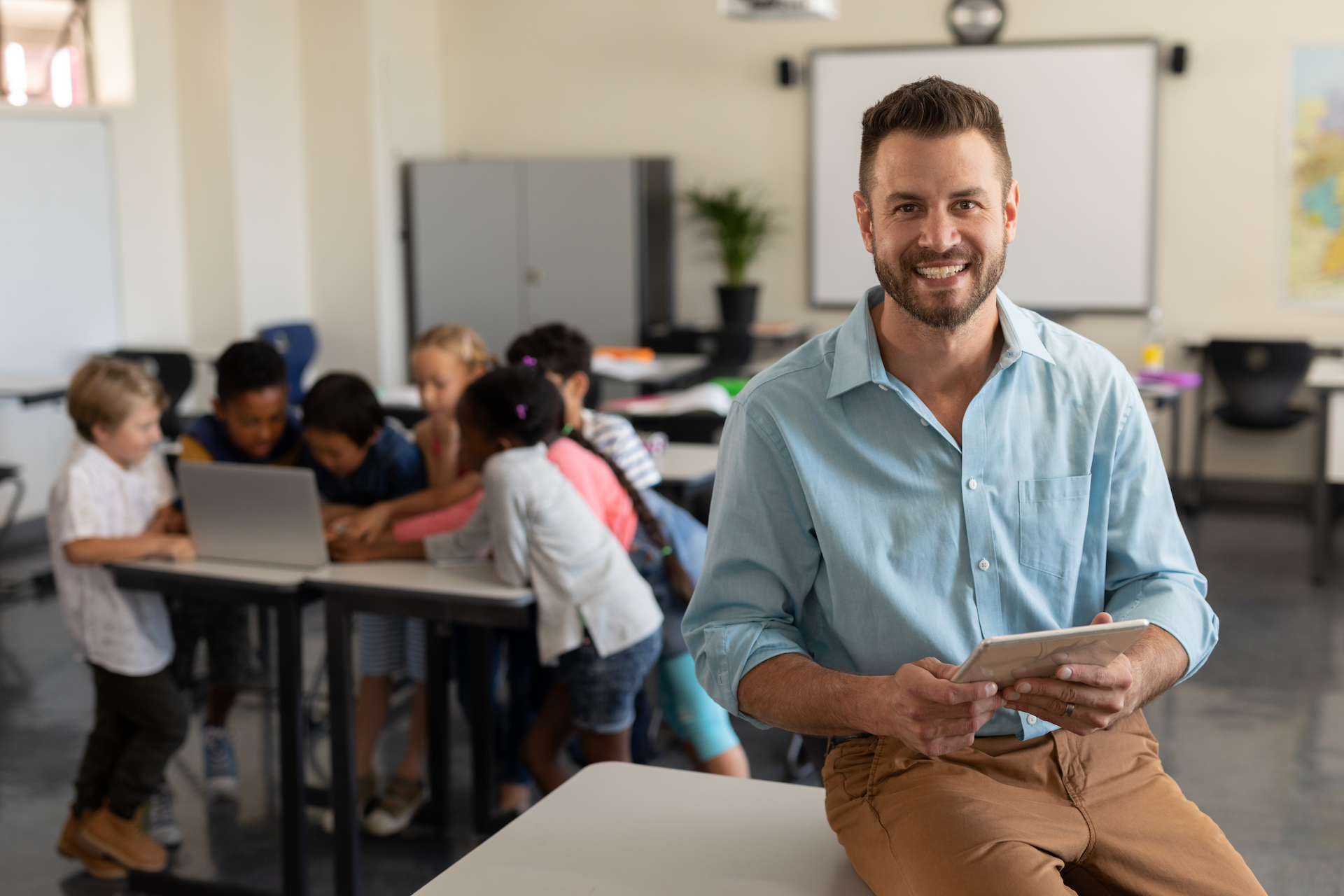 Happy teacher with tablet