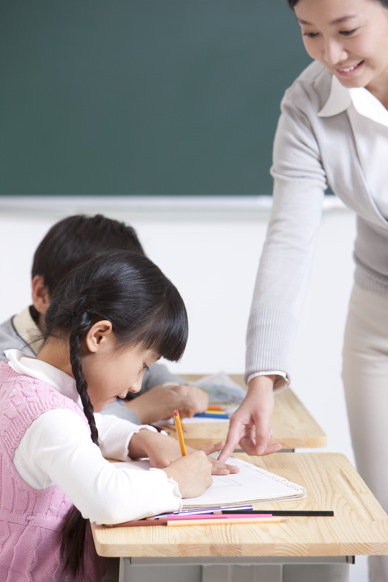 Smiling teacher teaching students