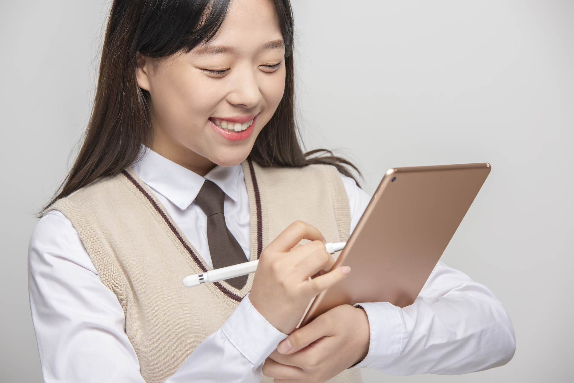 Female student using tablet smiling