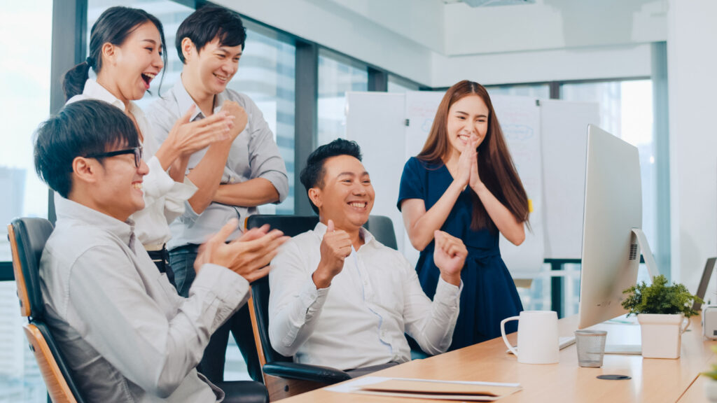 group of happy teachers in the office